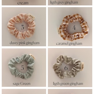 May include: Eight scrunchies in various colors and patterns are displayed. Colors include cream, light grey gingham, dusty pink gingham, caramel gingham, sage green, light green gingham, dark grey gingham, and rose. Each scrunchie has a small tag that says "Sir Cus".
