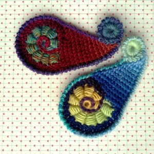 Freeform crochet paisleys / swirls on a light background.