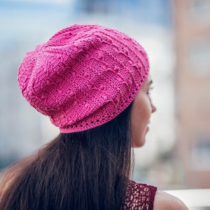 Pink  slouchy  crochet  beanie on a woman's head with dark hair