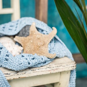 Half-circle crochet purse with one handle, linen texture, laid on a chair – relaxed summer vibe, Summer Cloud pattern