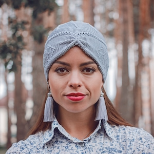 A summer turban crafted using Tunisian crochet technique, worn by a woman.