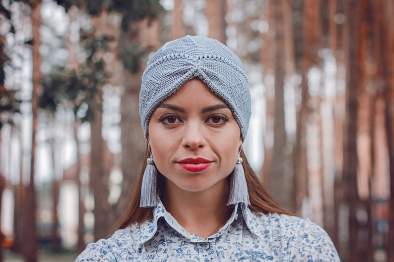 A summer turban crafted using Tunisian crochet technique, worn by a woman.