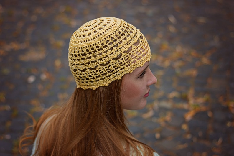 Intricate crocheted lace design of the women`s summer hat that catches the eye.