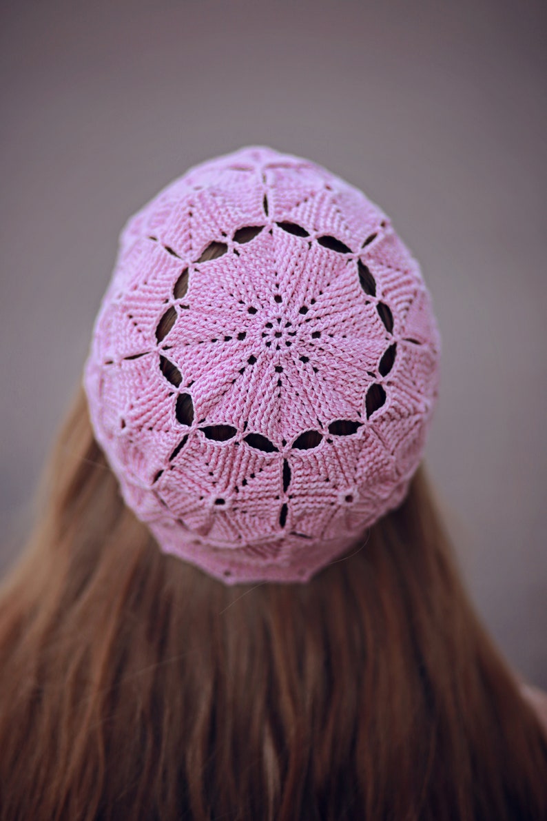 Close-up from behind: crocheted beret made from fine yarn with textured motifs.