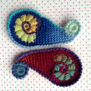 Two handcrafted applique in paisley form.