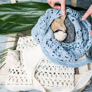 Summery handmade crochet bag in light blue, minimal lace pattern, styled for beach vibes with marine props