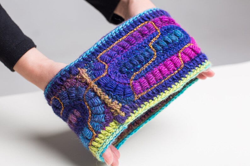 May include: A colorful crocheted headband with a textured design and gold thread accents.