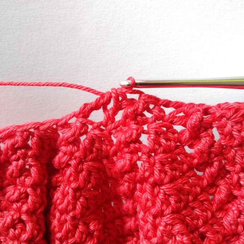 Crochet process with red  fine  yarn
