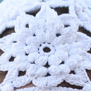 Close-up photo of the white crochet flower