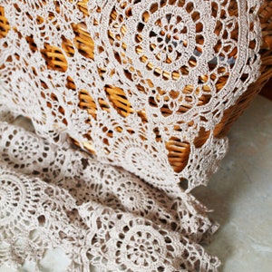 Summer crochet scarf in beige linen yarn hanging naturally on a hanger, showing beautiful draping and airy texture.