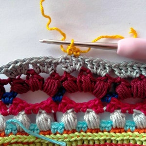 Crochet work in progress photo with multicolored design.