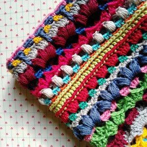 Close-up photo of a brim of handmade multicolored striped gipsy crocheted hat.