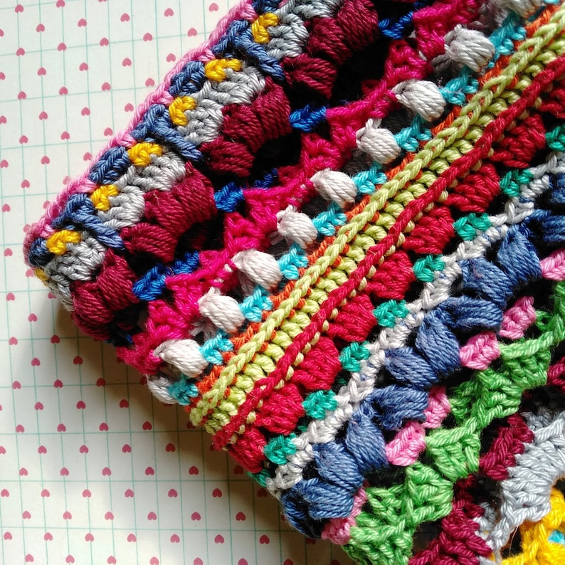 Close-up photo of a brim of handmade multicolored striped gipsy crocheted hat.