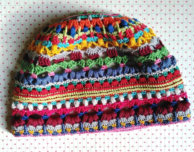 Close-up photo of a handmade multicolored striped funky crocheted hat.