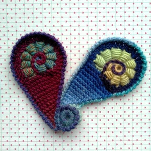 A couple of crochet appliques based on freeform paisley.