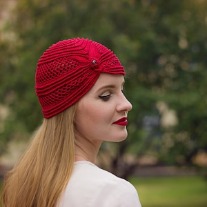 Red crochet mesh hat with bead accent wearing by woman with red lips