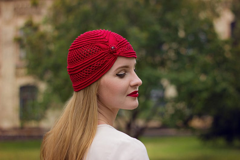 Red crochet mesh hat with bead accent wearing by woman with red lips