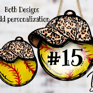 May include: Two softball ornaments with a leopard print baseball cap on top. One ornament has the number 15 on it.