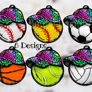 May include: Six different sports ball designs with a leopard print and rainbow colored baseball cap on top. The balls include baseball, softball, soccer, basketball, tennis, and volleyball.