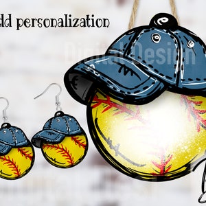 May include: A pair of earrings featuring a yellow softball with a blue baseball cap on top. The earrings are silver and have a hook closure. The softball is outlined in black and has red stitching. The baseball cap is blue with a white brim and a white stitching detail. The image also shows a larger version of the same design, which is hanging from a string.