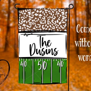 May include: A green and white garden flag with a brown and white leopard print pattern at the top. The middle section has a white background with the text "The Dusins" in black. The bottom section is a green football field with white yard lines and the numbers 40, 50, and 40.