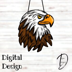 May include: Digital design of an eagle's head with a stern expression. The eagle has white feathers on its head, brown feathers on its neck, and an orange beak. The text "Digital Design" is at the bottom.