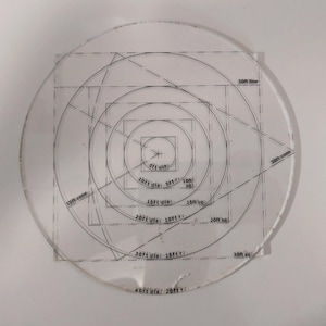 May include: A clear plastic circle with concentric circles and squares printed on it. The circles are labeled with diameters in feet, from 5 feet to 40 feet. The squares are labeled with side lengths in feet, from 5 feet to 30 feet.