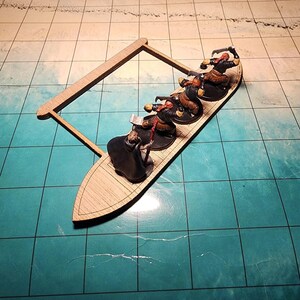 May include: A wooden boat with four miniature figures wearing black and red clothing. The figures are rowing the boat. The boat is on a blue and white grid.