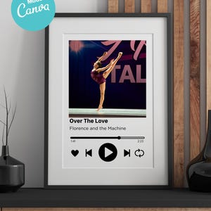 May include: Framed print featuring a dancer in a burgundy leotard performing a split leap. The print includes a music player interface with the song title "Over The Love" by Florence and the Machine. A teal circle with "Made in Canva" is in the upper left corner.