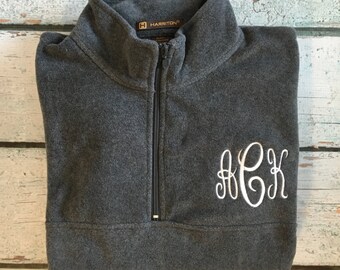 May include: A gray fleece pullover with a quarter-zip closure and a white embroidered monogram "HCK".