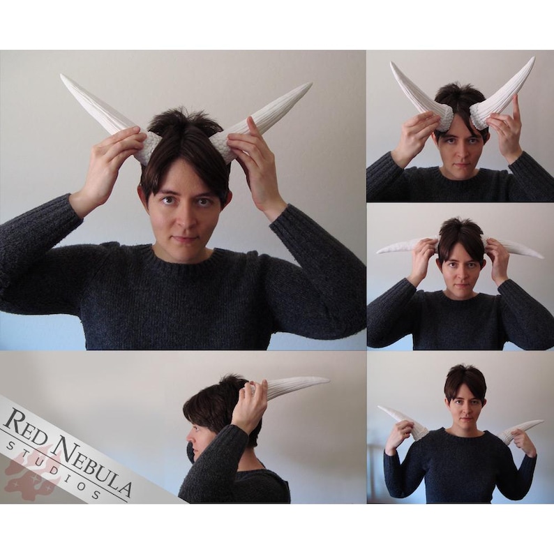 May include: A person is wearing a pair of white horns on their head. They are holding the horns in place with their hands. The horns are long and curved, and they are made of a smooth, white material.
