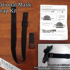 May include: A black adjustable mask strap kit with two straps and a buckle. The kit is shown on a wooden surface with instructions for attaching the straps to a mask. The text "Optional Mask Strap Kit" is at the top of the image. The text "RED NEBULA STUDIOS" is at the bottom of the image. The text "Example on a finished mask. Note: Strap kit comes as a separate piece." is at the bottom of the image.