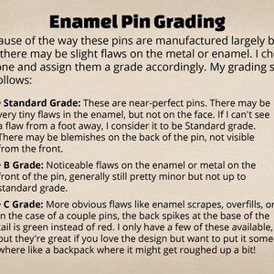 May include: Text on a beige background explains enamel pin grading. The text describes three grades: Standard, B Grade, and C Grade, based on the presence and severity of flaws in the enamel or metal of the pins.