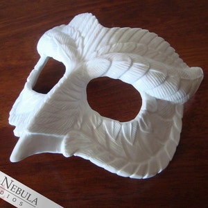 May include: White owl mask with detailed feather design. The mask has a single eye hole and a beak-like nose.