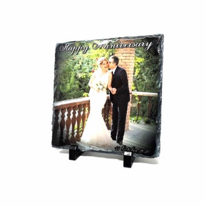 May include: A black slate photo frame with a couple's wedding photo and the text "Happy Anniversary 11 October 2020".