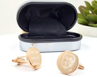 May include: A pair of gold cufflinks in a black box. One cufflink has a photo engraved on it, and the other cufflink has the text "with you today & always" engraved on it.
