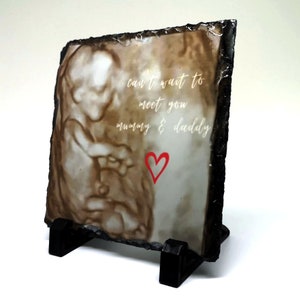 May include: A slate plaque with a sonogram image and the text "can't wait to meet you mummy & daddy" with a red heart.