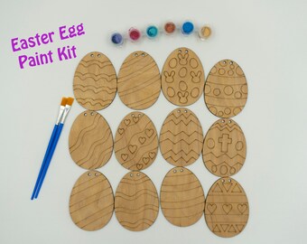 May include: A set of 12 wooden Easter egg shapes with different designs, ready to be painted. The kit includes two paintbrushes and six small bottles of paint.
