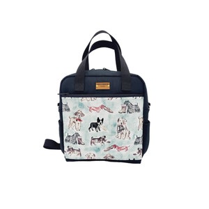 May include: Black canvas tote bag with a zippered pocket and a shoulder strap. The front of the bag features a colorful print of various dog breeds.