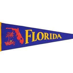 May include: A blue pennant with a yellow border and the word "FLORIDA" in yellow letters. The pennant also features a red outline of the state of Florida with a palm tree and a setting sun.