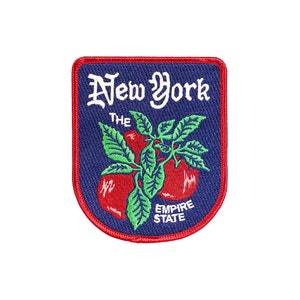 May include: Embroidered patch featuring a red, white, and blue design. The patch has a navy blue background with the words "New York" in white script. Below the text is a graphic of red tomatoes with green leaves, and the words "Empire State".