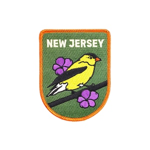 May include: An embroidered patch with a green background and an orange border. The patch features a yellow bird with black wings and a purple flower on a branch. The text "NEW JERSEY" is written in white letters at the top of the patch.