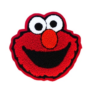 May include: A red Elmo face with a black mouth and a red border. The eyes are white with black pupils, and the nose is orange. The design is on a white background.