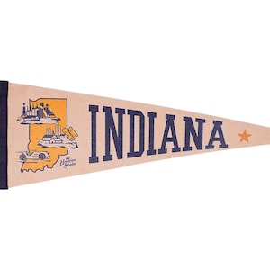 May include: Tan pennant with the word "INDIANA" in navy blue block letters. A gold outline of the state with illustrations of buildings and a car is on the left. A small orange star is on the right.
