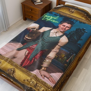 May include: A bedspread with a framed portrait of a person in a green vest and red skirt, holding a skull. The portrait has a gold frame and the text "Emmerich Vokarin" in neon green.