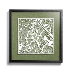 May include: A framed map of Vienna, Austria, with a green background and a white paper cutout of the city's streets. The map is framed in black and has the words "Vienna" and "Donau" printed at the bottom.