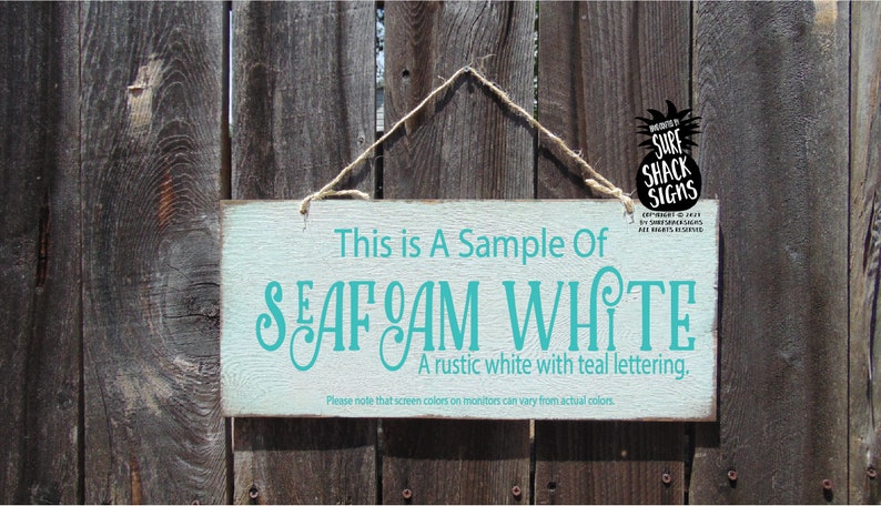 a sign hanging on a wooden fence that says, this is a sample of sea