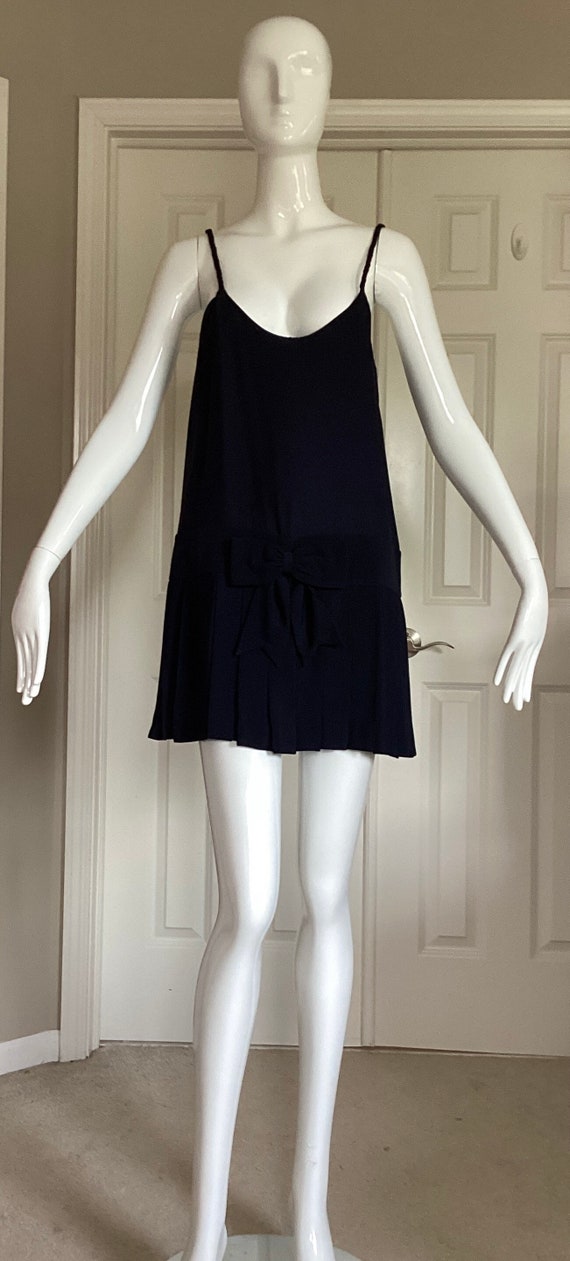 Moschino Couture, Moschino Couture, vintage 1991, unworn, size 8 spaghetti strap pull over black drop-waist dress with pleated mini skirt.