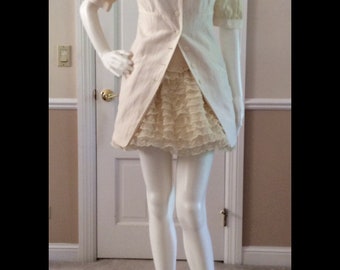 May include: A white dress with a lace skirt and a button-up bodice. The dress has short sleeves and a scoop neckline.