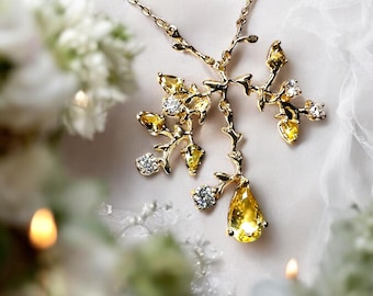 Colgante artesanal de oro de 14k con zafiro amarillo: diseño de enredaderas y hojas.